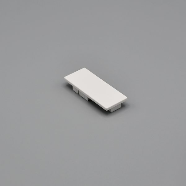 White, Fabtex side channel base end cap for roller shade side channels. It shows the front face side.