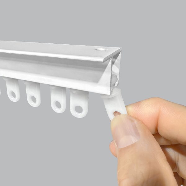 White Fabtex friction slide carrier is inserted into a drapery track