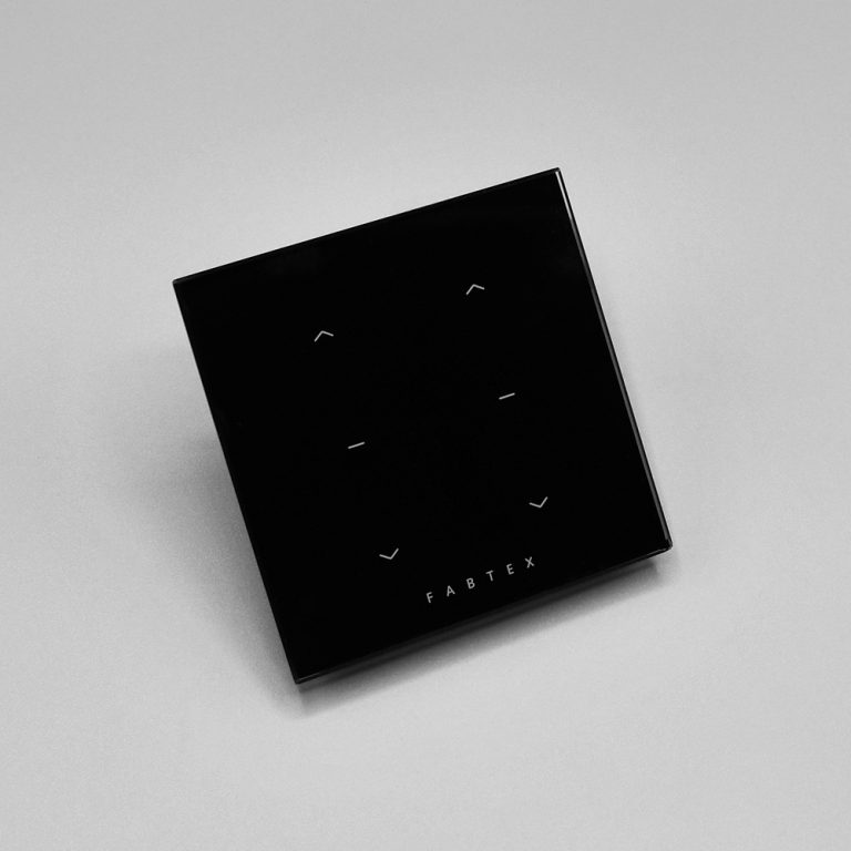 Black, Fabtex surface-mount, 2-channel control/remote for roller shades. Connects via radio frequency.